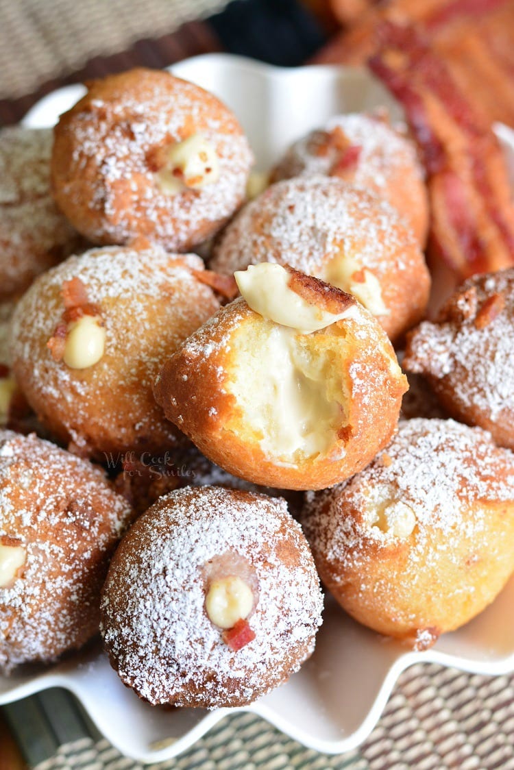 Bacon Brown Sugar Cream Doughnut Holes in a bowl with a slice of bacon as a garnish 