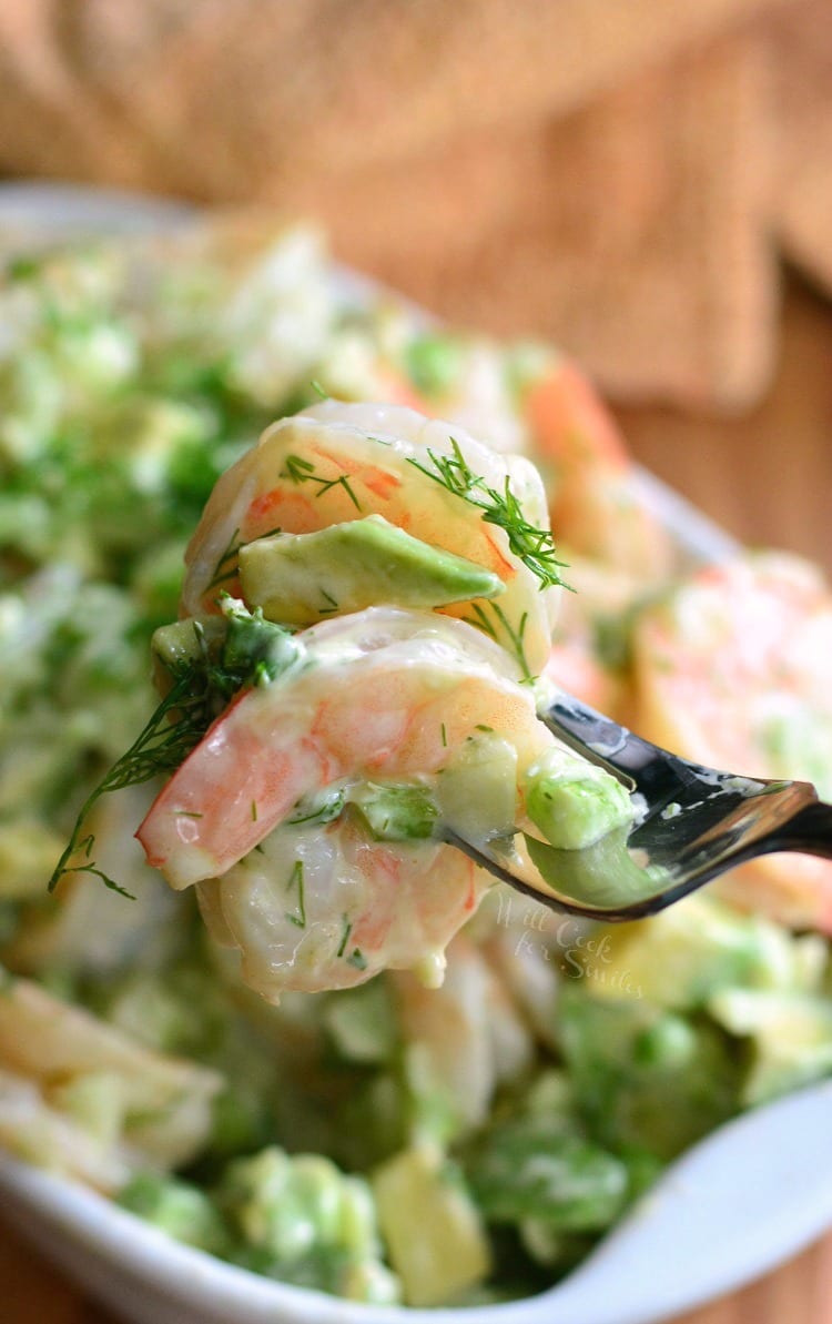 a couple of shrimp from the salad on a fork 