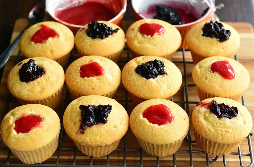 cupcakes filled with fruit strawberry and blueberry filling.