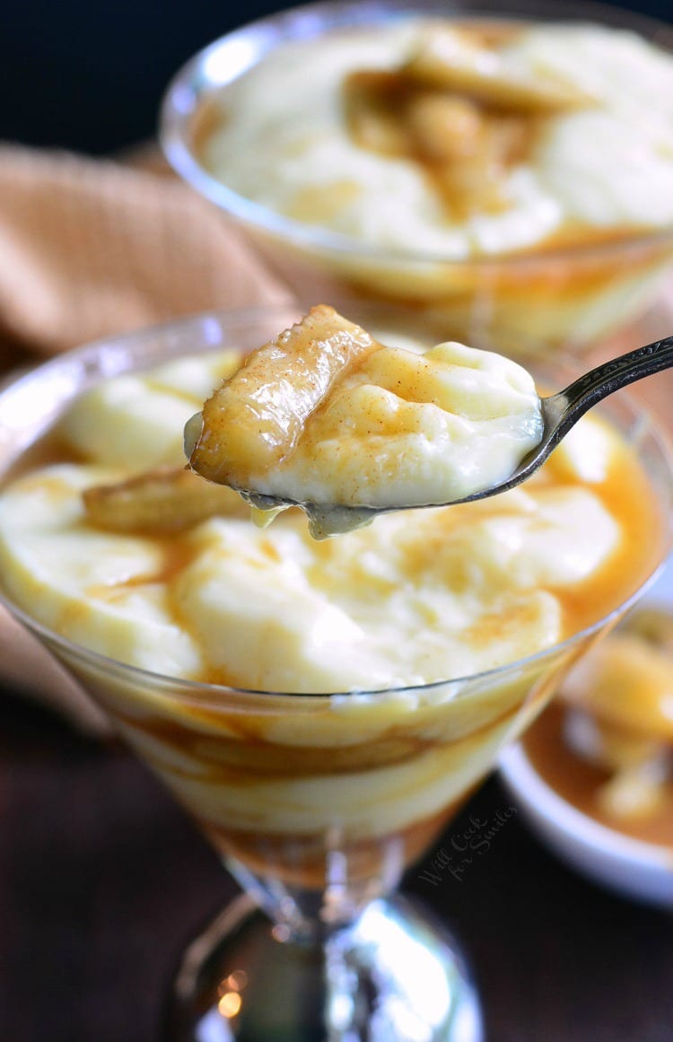 Bananas Foster Pudding Parfait in a glass with a spoon scooping some out 