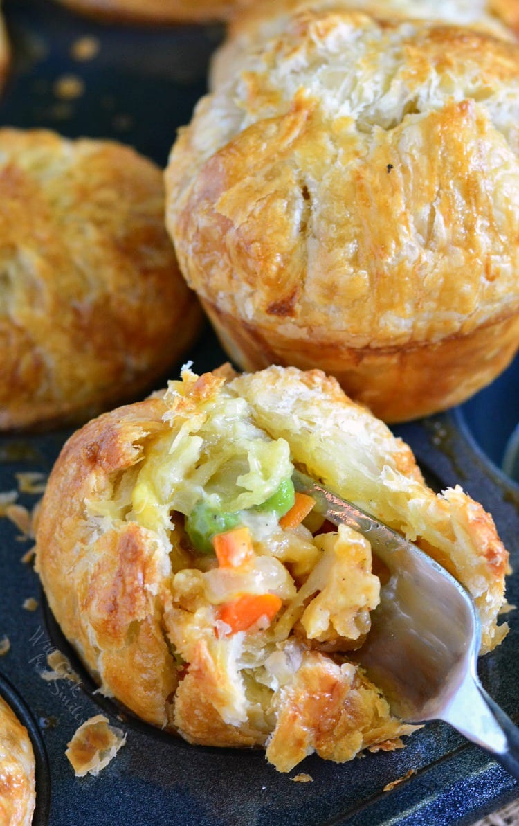 Chicken Pot Pie Pockets in a muffin tin with a fork inside one of them 