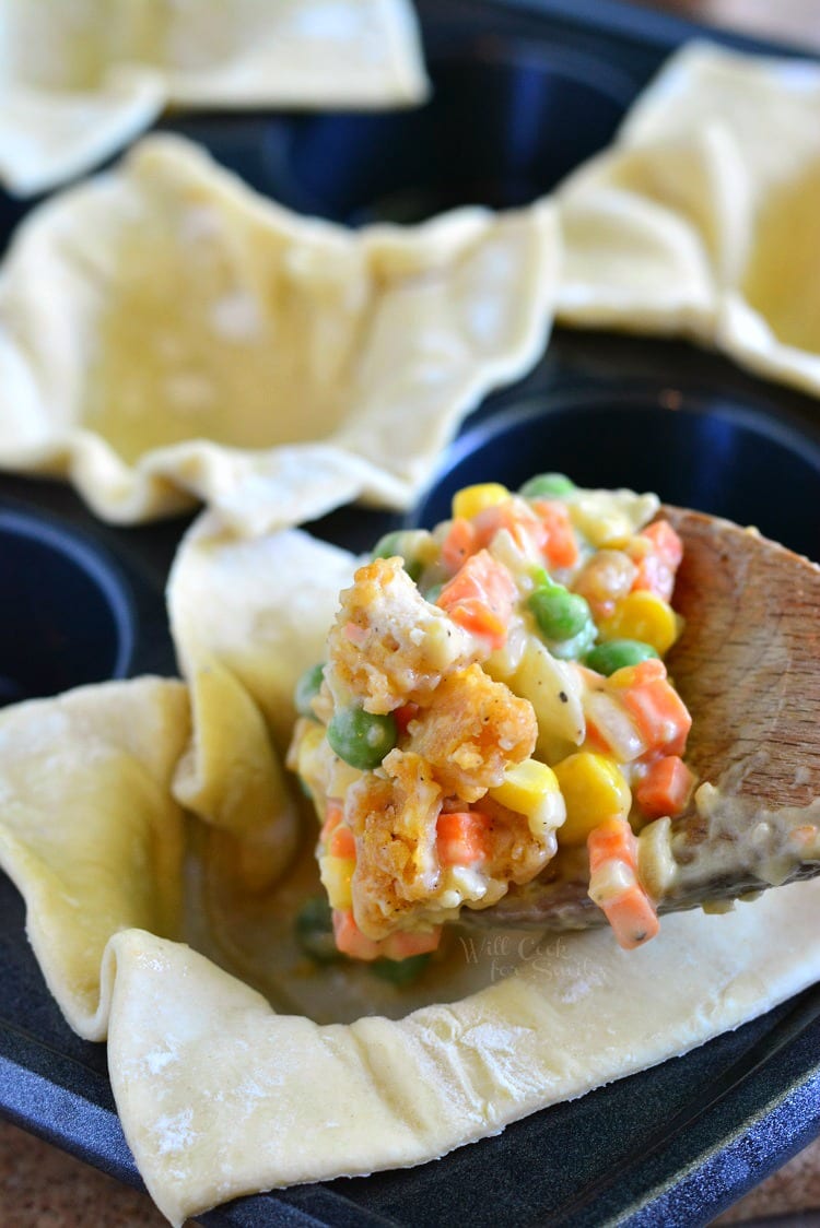 putting chicken mixture inside the uncooked pie crust 