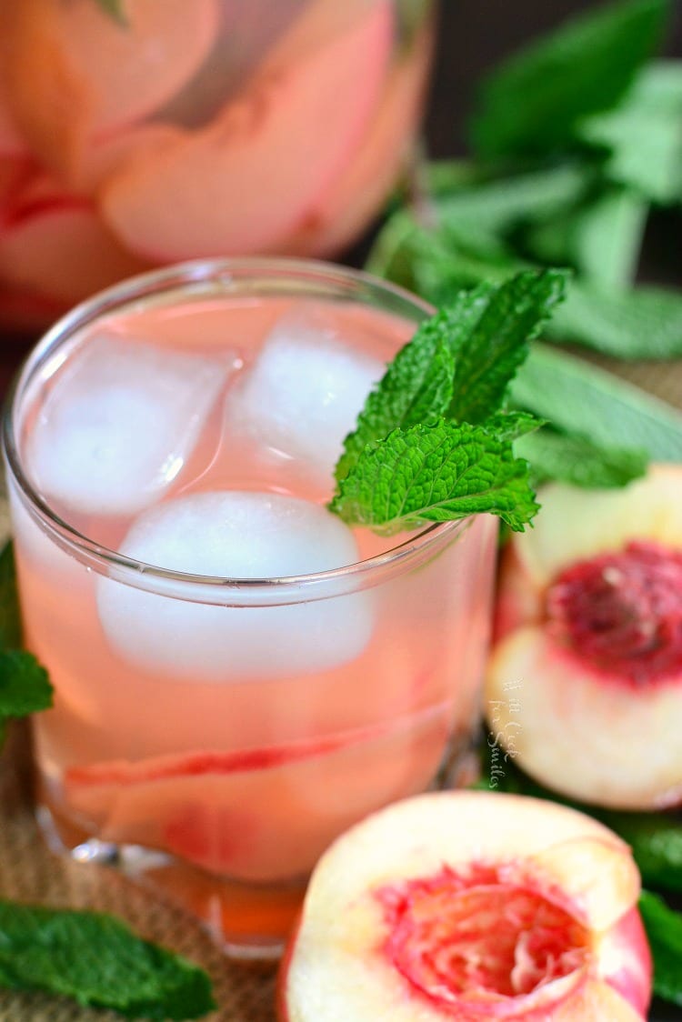 above photo of mint and peach spritzer in a glass.