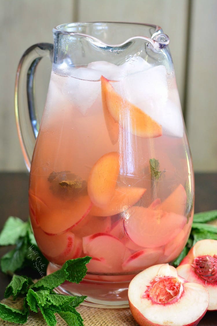 Pitcher filled with mint and peaches.