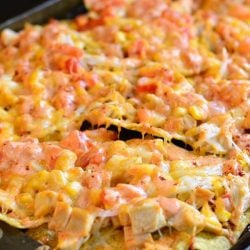 horizonal photo of nachos on a sheet pan.