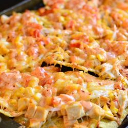 horizonal photo of nachos on a sheet pan.