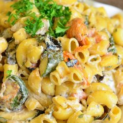 White decorative bowl filled with grilled vegetable pasta salad