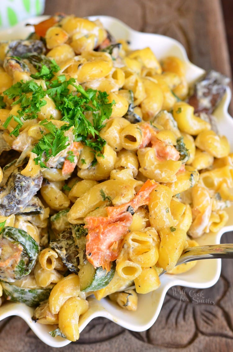 Grilled Vegetable Pasta Salad in a bowl on a cutting board 