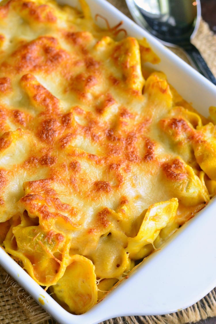 Spicy Three Cheese Pumpkin Tortellini Bake in a white casserole dish 