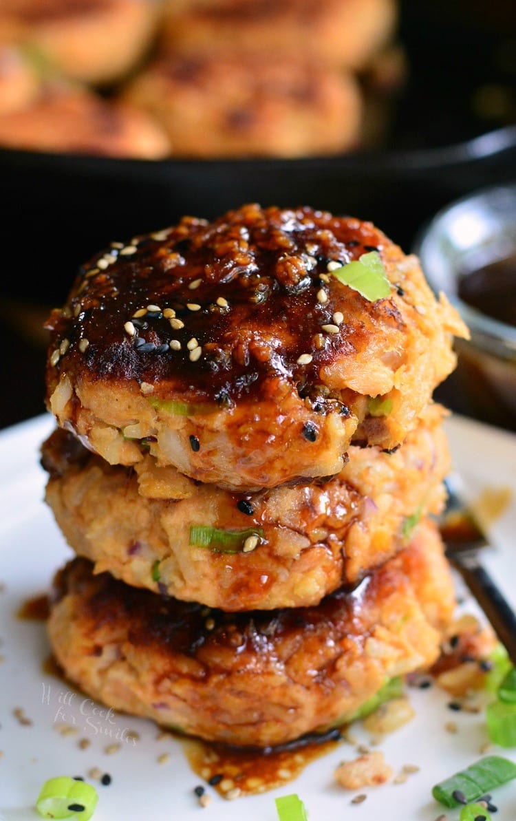 stacked cooked salmon patties topped with sauce