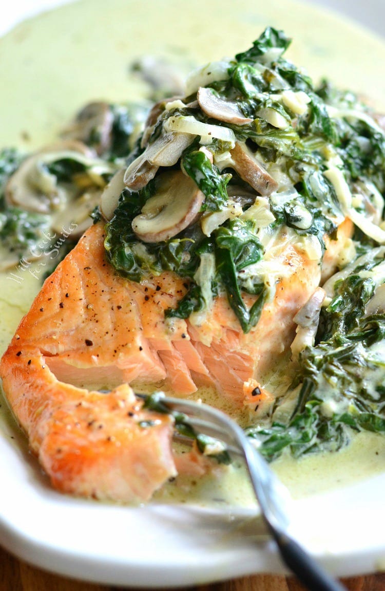 Salmon Florentine on a white plate with a fork 