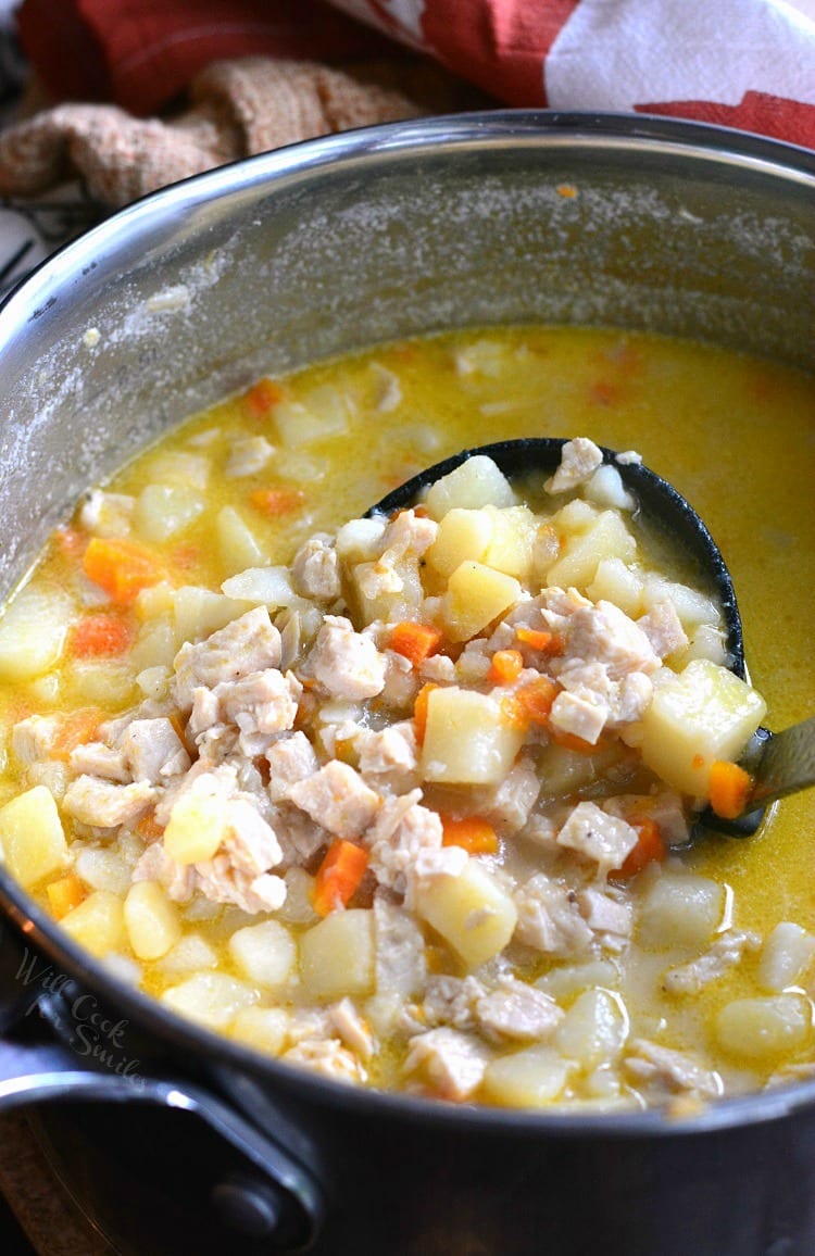 Creamy, Chunky Turkey Potato Soup in a pot with a ladle  