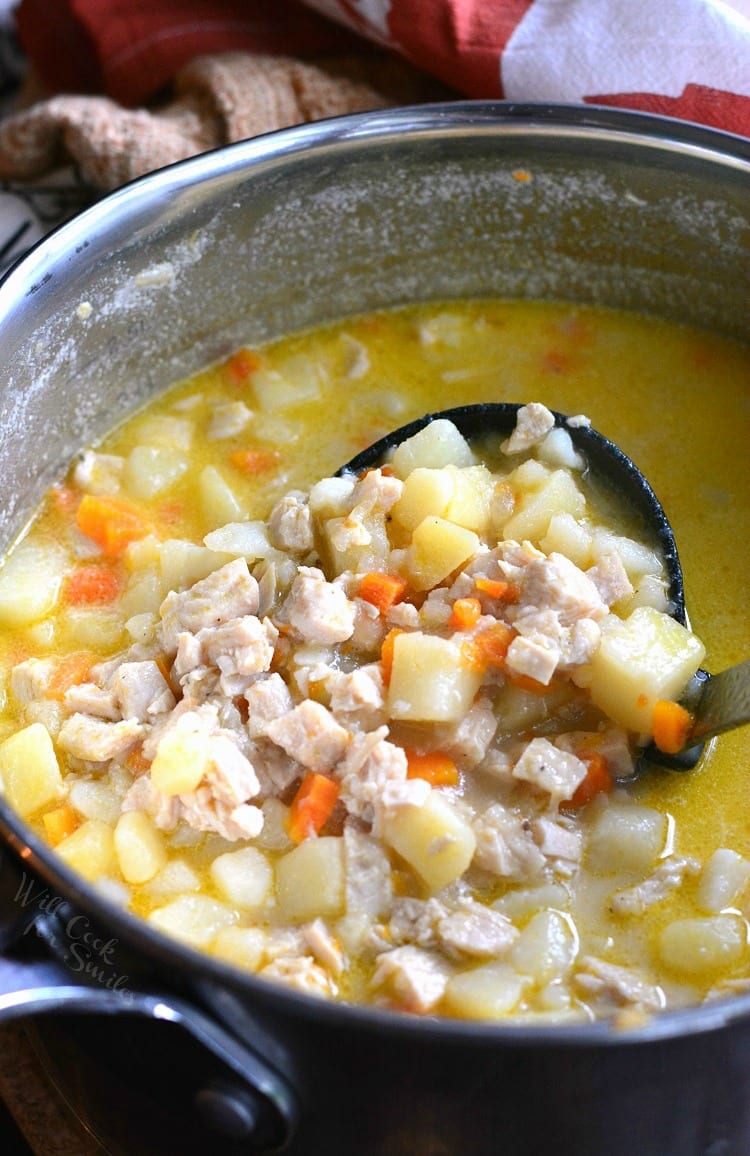 Creamy, Chunky Turkey Potato Soup in a pot with a ladle 