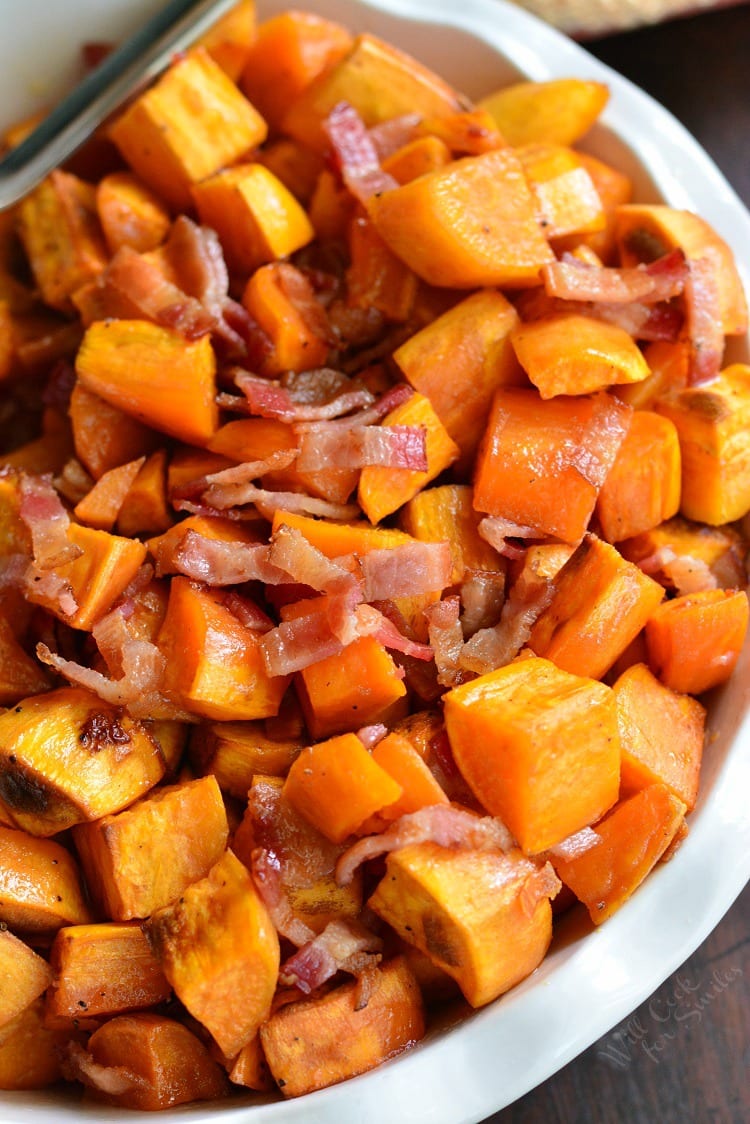 Maple Bacon Roasted Sweet Potatoes in a serving bowl on a wood table