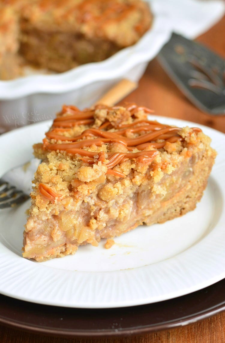 Caramel Apple Cookie Pie slice on a white plate with the rest of the pie in the pie pan in the background