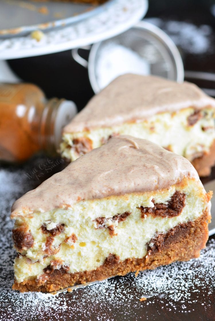 2 Cinnamon Roll Cheesecake slices on a cutting board 