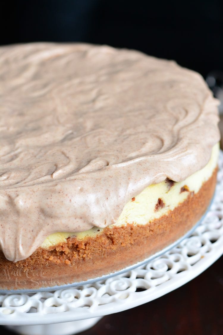 Cinnamon Roll Cheesecake on a cake stand 