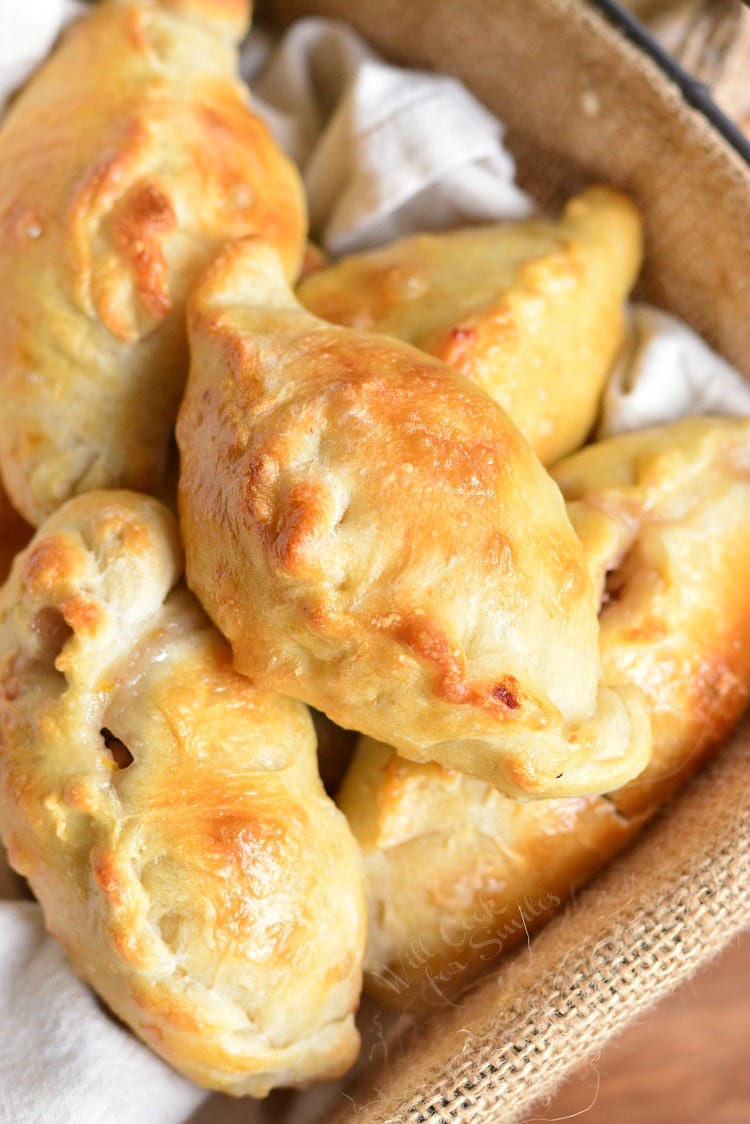 Turkey Cranberry Baked Piroshki in a small basket with a dish cloth in the bottom 