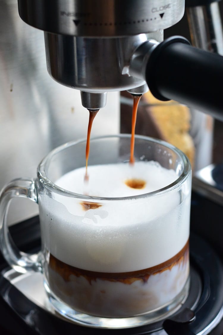  De’Longhi Dedica DeLuxe Manual Espresso Machine and glass with espresso going into it 