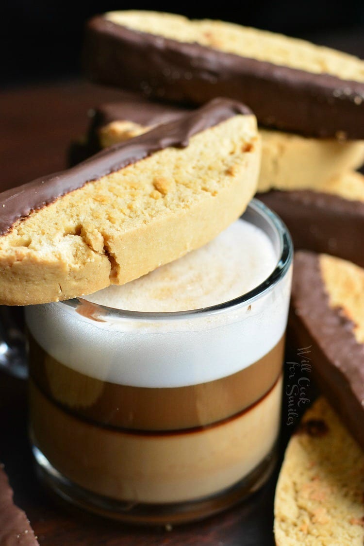 Dark Chocolate Cappuccino Biscotti across mug with espresso in it 