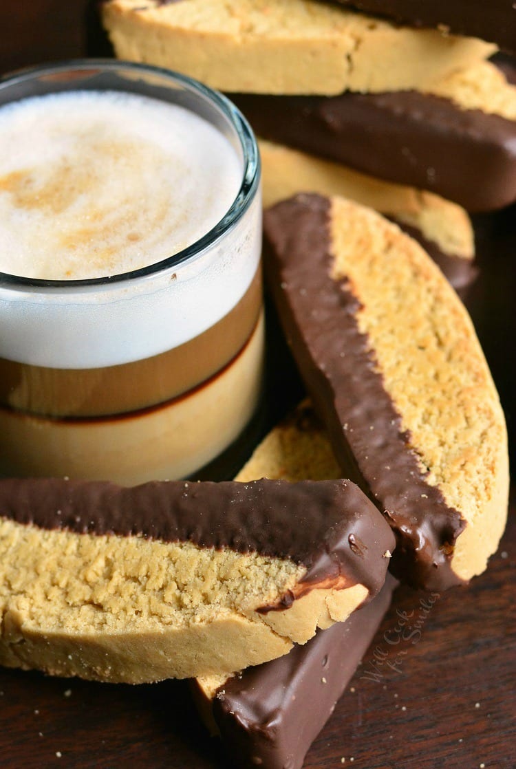 Dark Chocolate Cappuccino Biscotti on a cutting board with a glass of cappuccino 