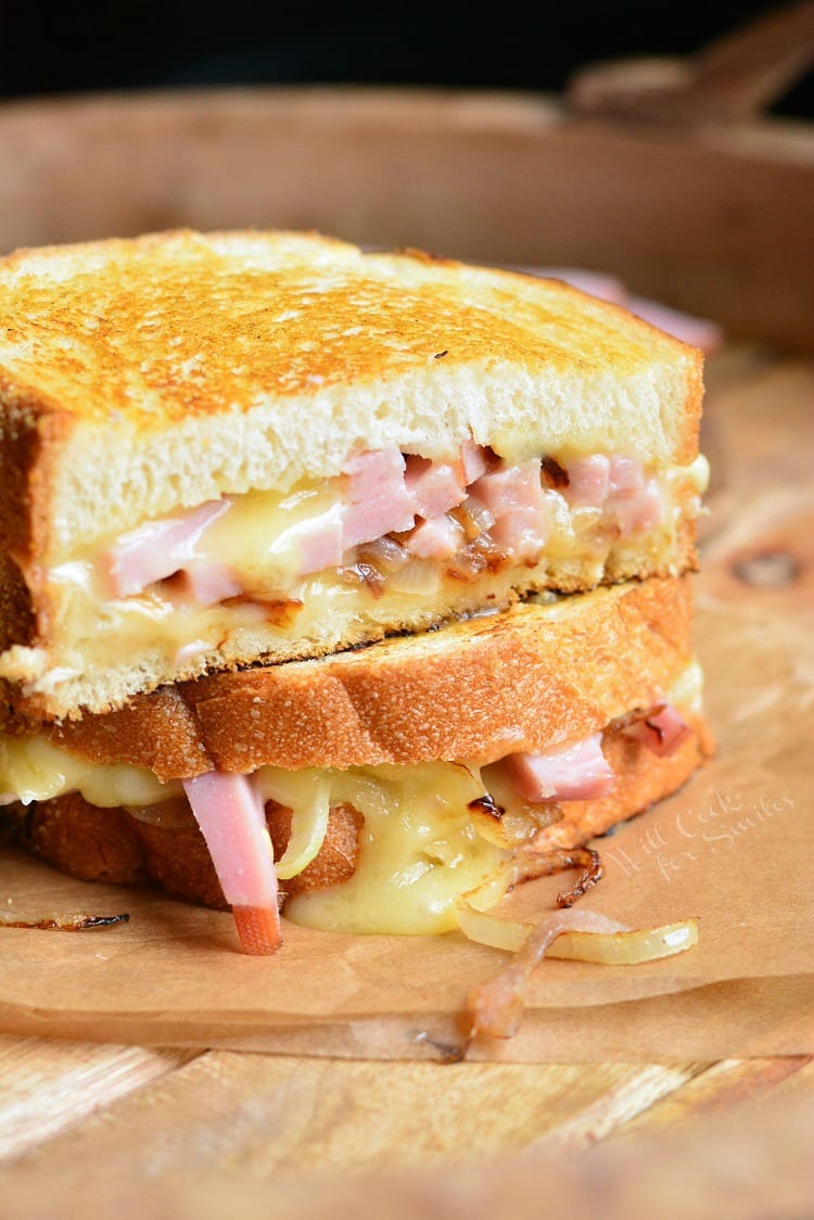 Ham and Brie Grilled Cheese Sandwich on parchment paper on a cutting board 