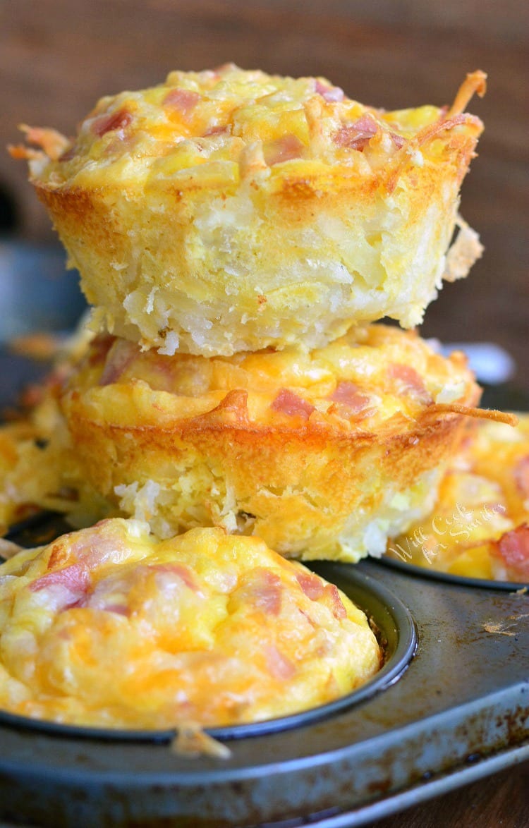 Ham Egg and Cheese Hash Brown Breakfast Muffins stacked on a muffin pan 
