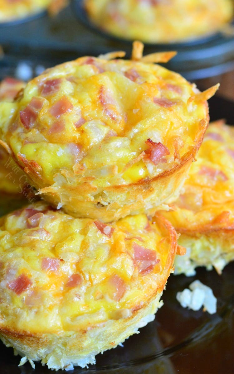 Ham Egg and Cheese Hash Brown Breakfast Muffins stacked on a plate 