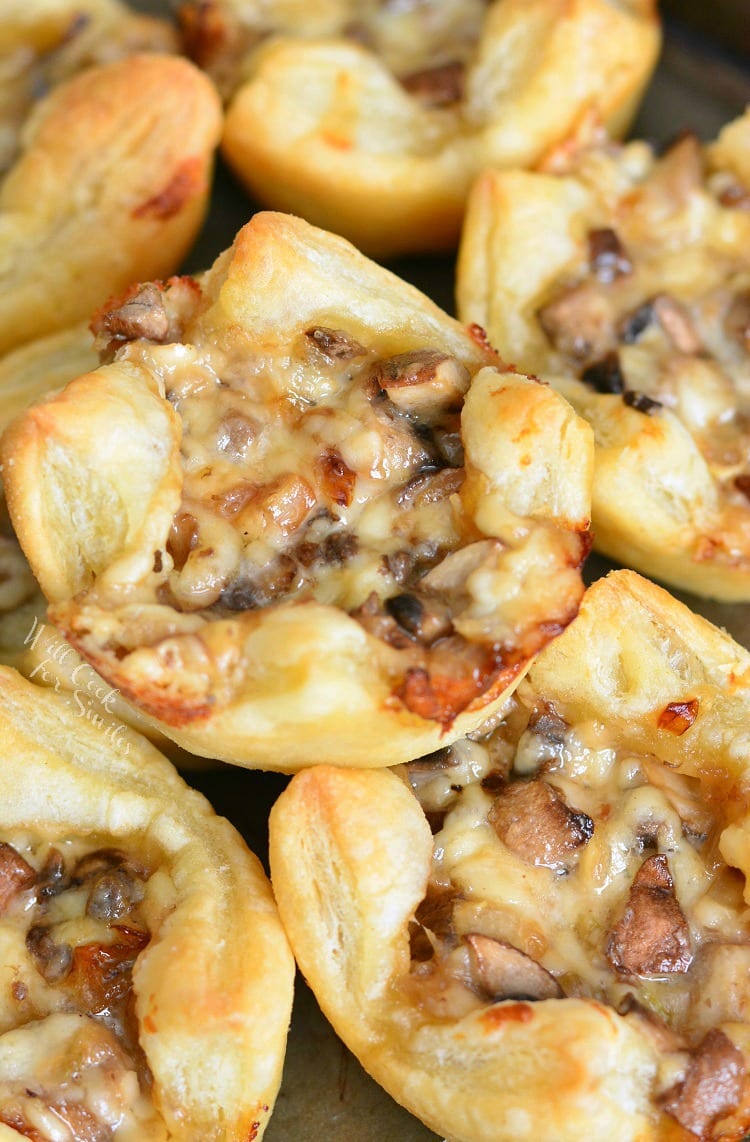 Mushroom Cheese Puff Bites stacked on a baking sheet 