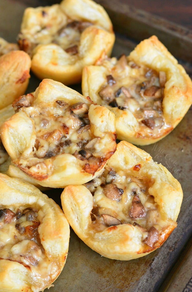 Mushroom Cheese Puff Bites stacked on a baking sheet 