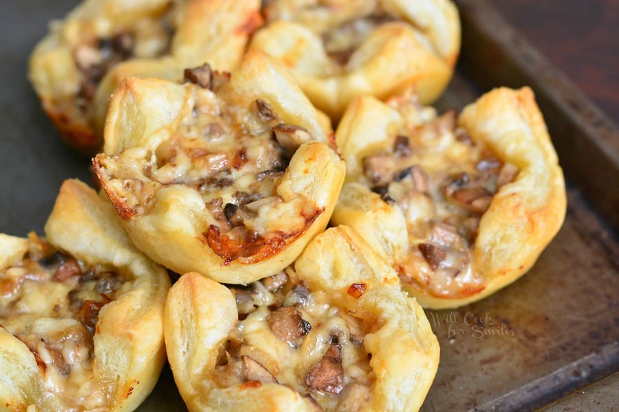 Mushroom Cheese Puff Bites stacked on a baking sheet 