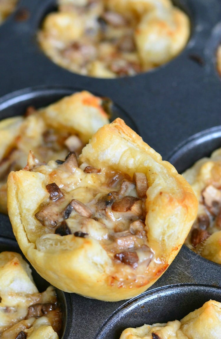 Mushroom Cheese Puff Bites stacked on a baking sheet 