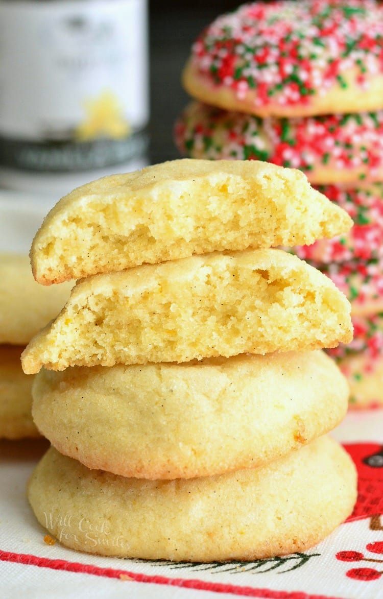 Sugar Cookies with Orange and Vanilla stacked on a plate some with sprinkles 