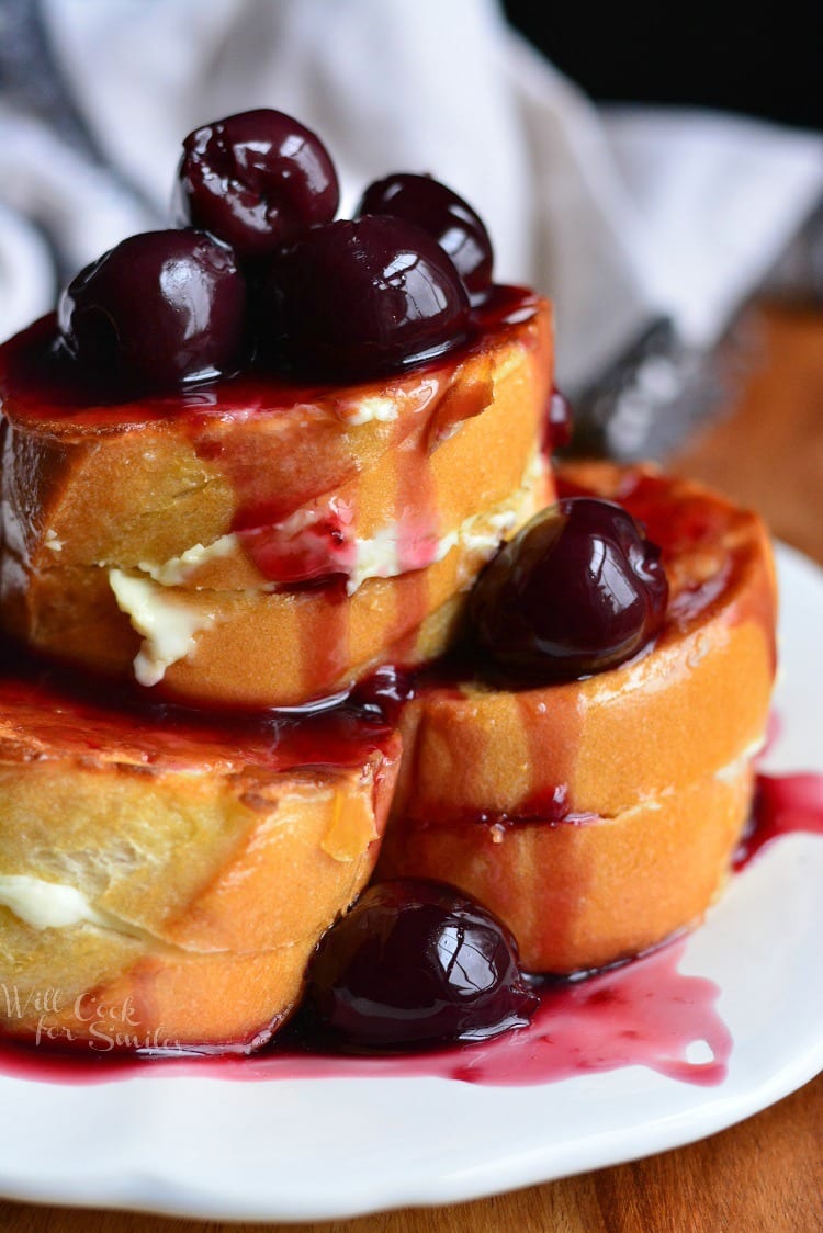Cherry Cheesecake Stuffed French Toast stacked on a plate on a plate 