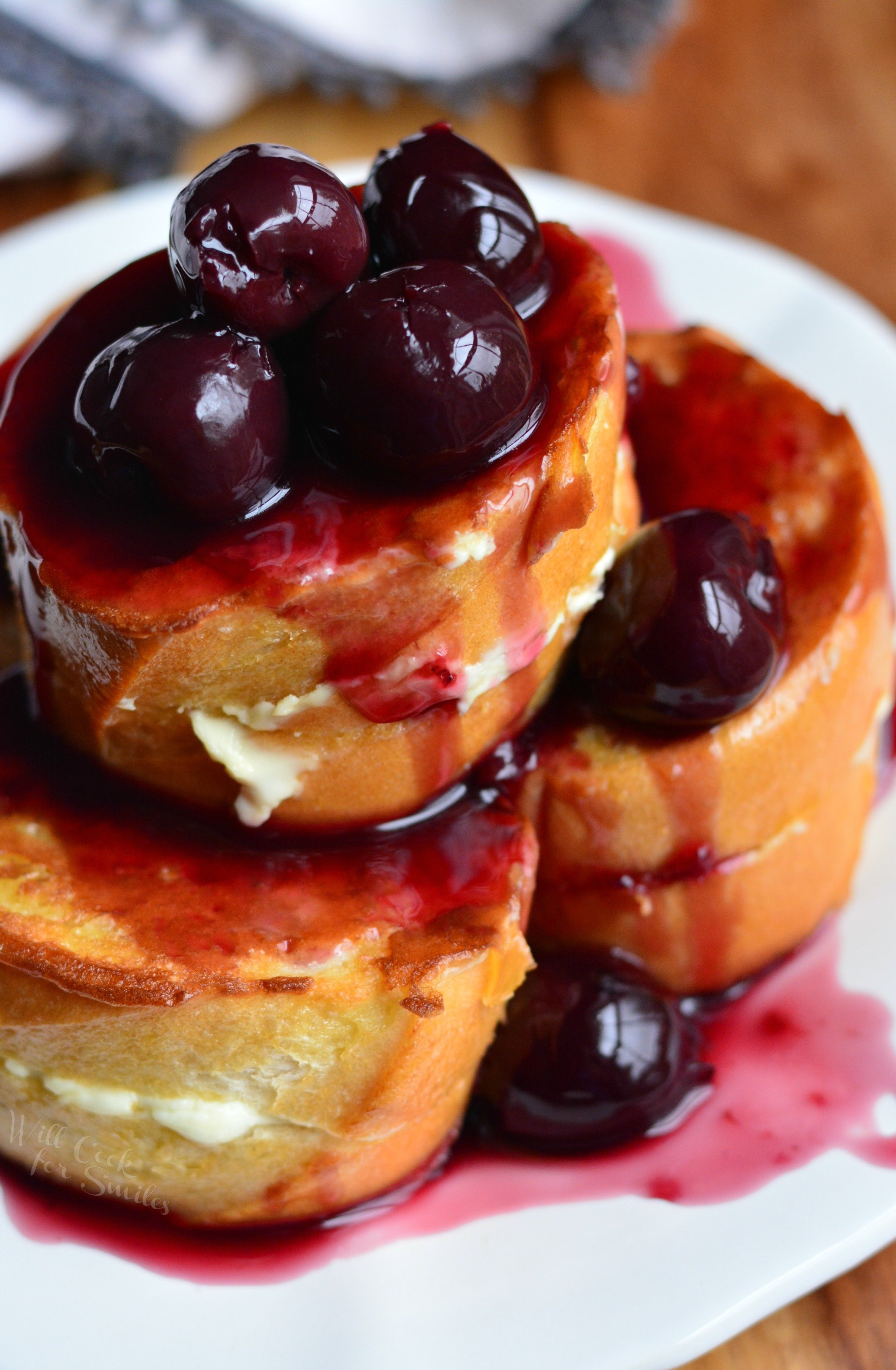 Cherry Cheesecake Stuffed French Toast stacked on a plate 