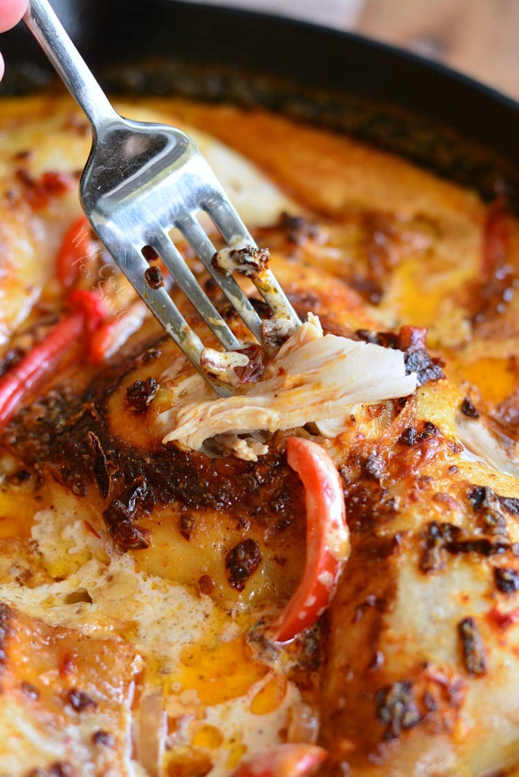 Creamy Chipotle Pepper Chicken Thighs in a pan with a fork 