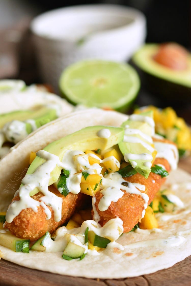 Crispy Fish Tacos with Cucumber Mango Relish on a cutting board 