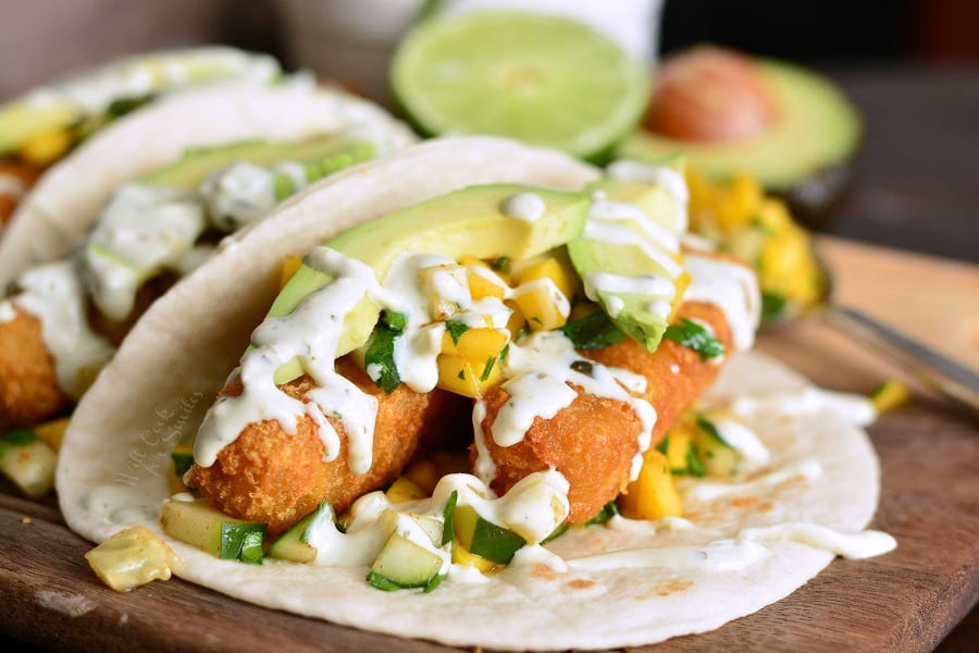 Crispy Fish Tacos with Cucumber Mango Relish on a cutting board 