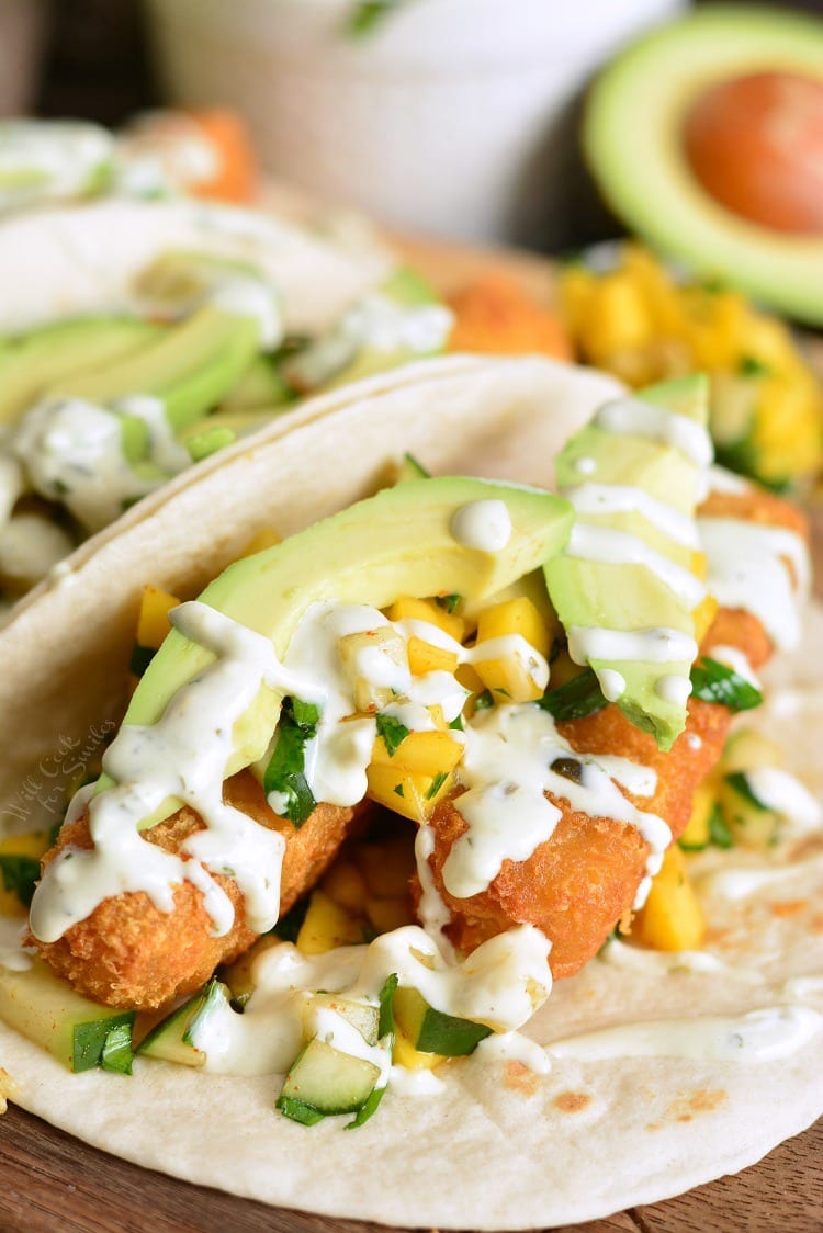 Crispy Fish Tacos with Cucumber Mango Relish on a cutting board 