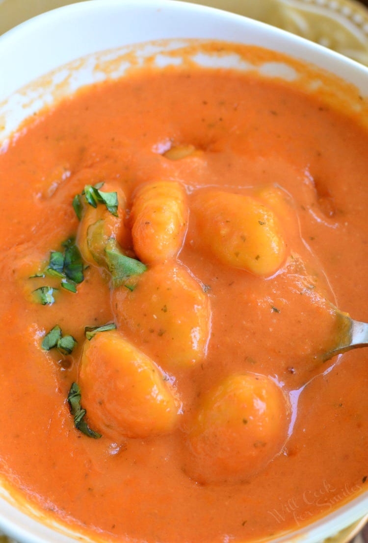 Homemade Tomato Soup with Gnocchi in a bowl with a spoon 