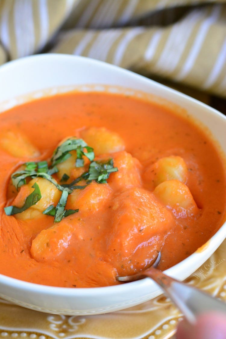 Homemade Tomato Soup with Gnocchi in a bowl with a spoon in the bowl 