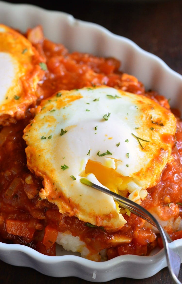 Shakshuka with Parmesan Polenta in a bowl with a fork 