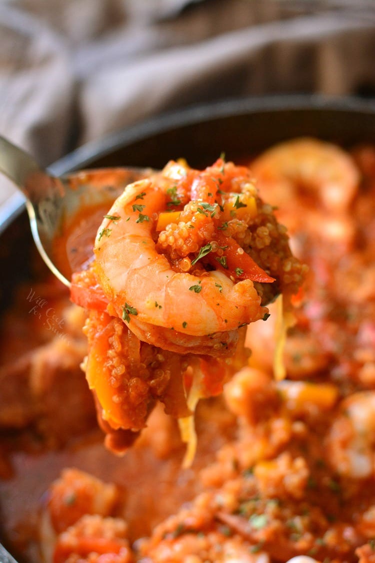 Smoked Sausage and Shrimp Jambalaya with Quinoa in a pan with a spoon scooping some out 