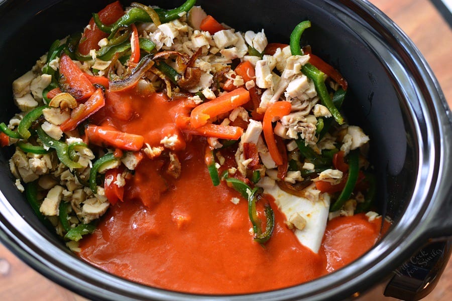 Ingredients for the enchilada dip in a slow cooker.