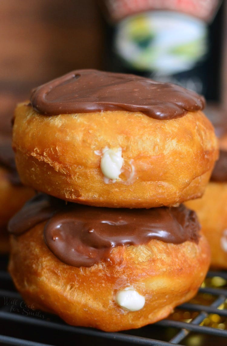 Bailey's Cheesecake Doughnuts stacked on a cooling rack 