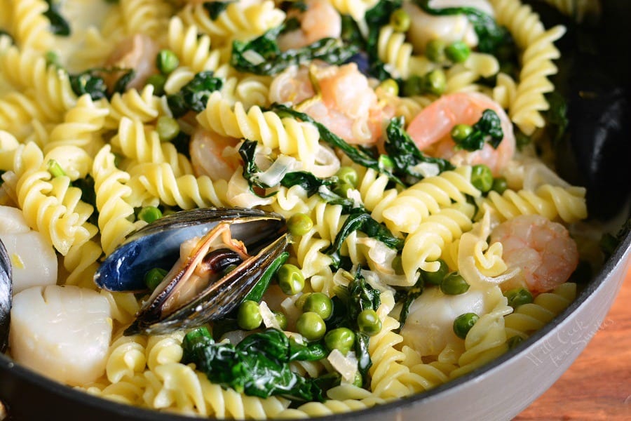 Creamy Spinach and Peas Seafood Pasta in a pan 