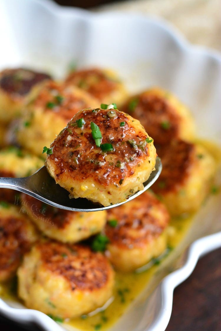 Shrimp Scampi Meatballs in a bowl with one being picked up with a spoon