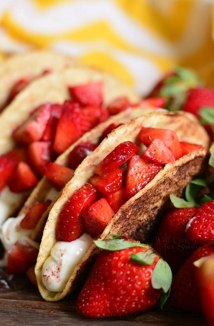 Cinnamon Strawberry Cheesecake Dessert Tacos on a cutting board 