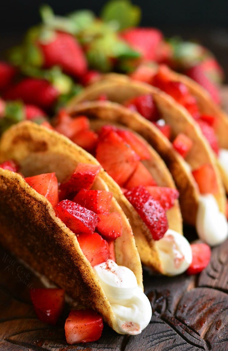 Cinnamon Strawberry Cheesecake Dessert Tacos. Crunchy corn taco shells are coated in butter and cinnamon sugar mixture, baked, and filled with no-bake cheesecake filling and fresh, cinnamon kissed strawberries. #tacos #strawberry #desserttaco
