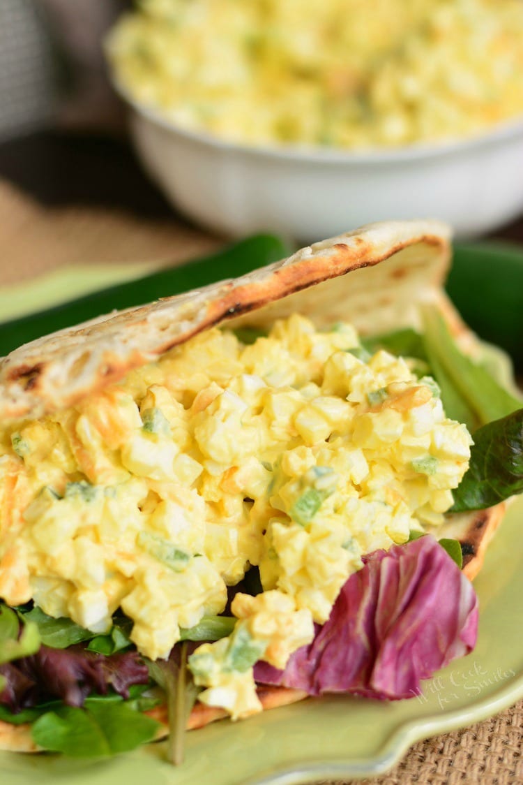 Jalapeno Cheddar Egg Salad in a pita on a plate with lettuce 